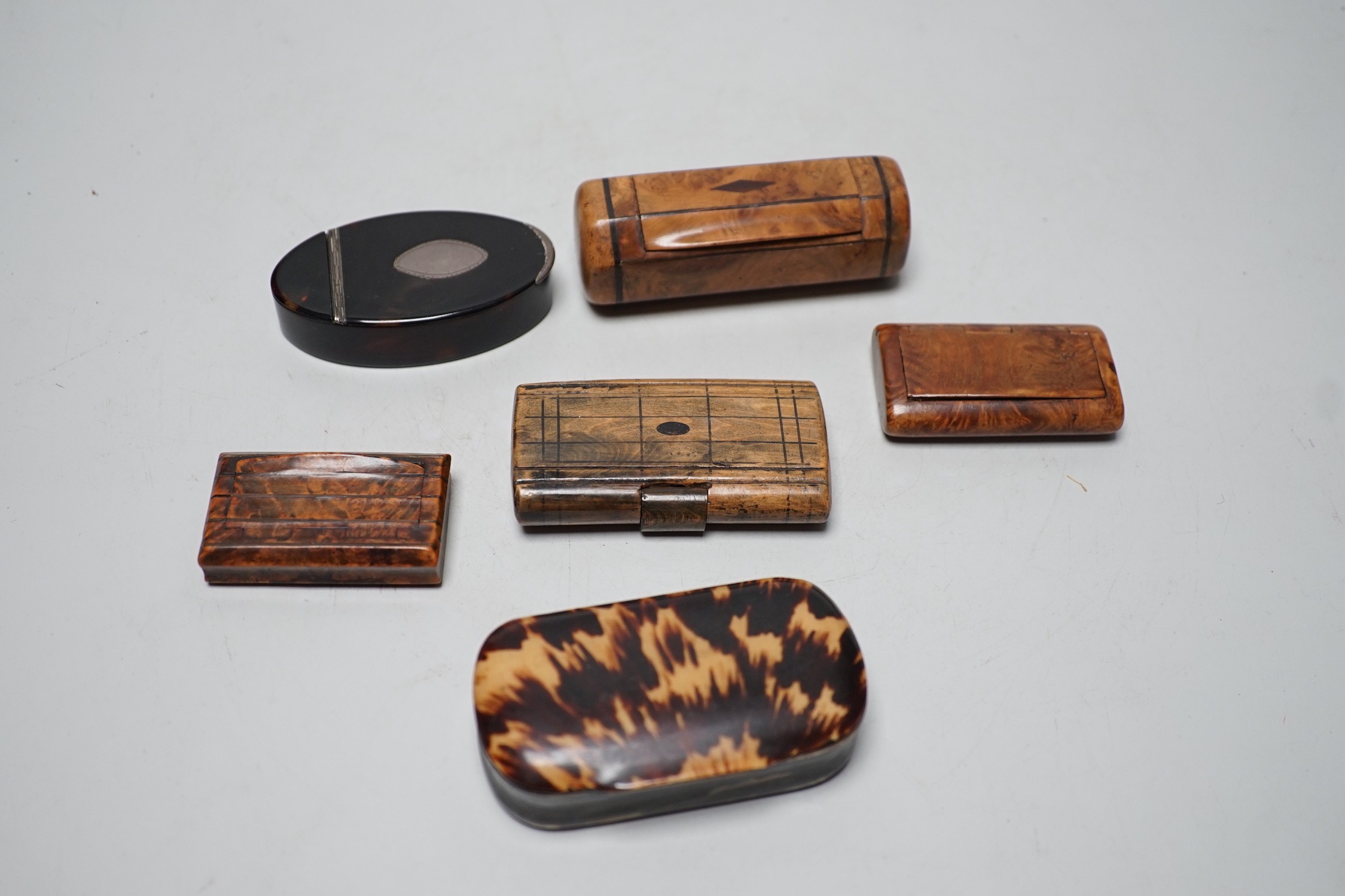 Two 19th century tortoiseshell snuff boxes and four treen snuff boxes.